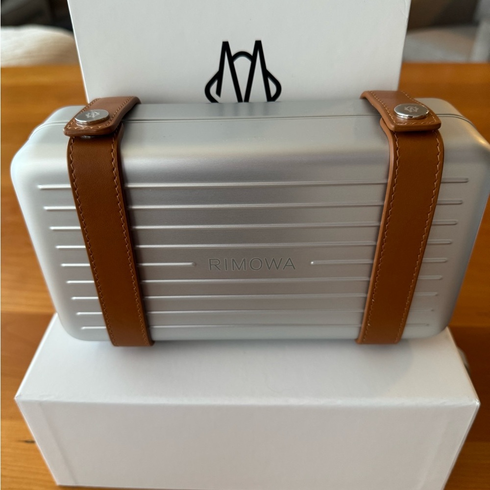 Brand new, never used, tags on, RIMOWA Cross Body Bag in Silver. 5”x 8.5” x 2.5”